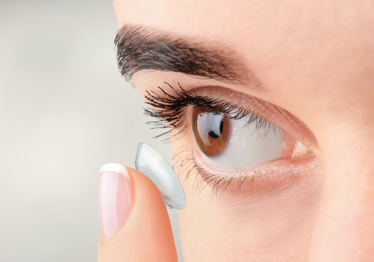 placing-contact-lens person placing contact lens on eye